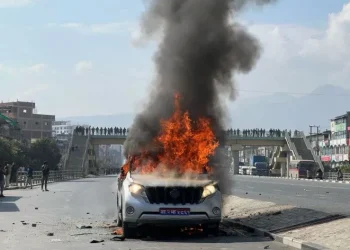 Protesting youths torch vehicle used by minister Jwala in Balkumari