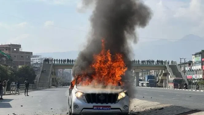 Protesting youths torch vehicle used by minister Jwala in Balkumari
