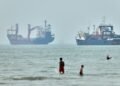 Cargo ship reports being struck in Strait of Hormuz as US, Iran claims about talks diverge