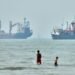 Cargo ship reports being struck in Strait of Hormuz as US, Iran claims about talks diverge